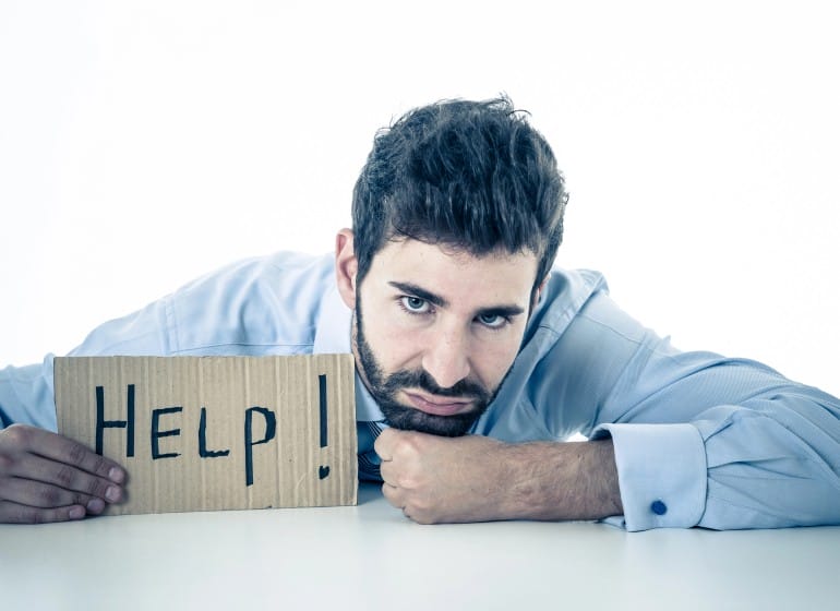 Concerned Businessman holding a help sign