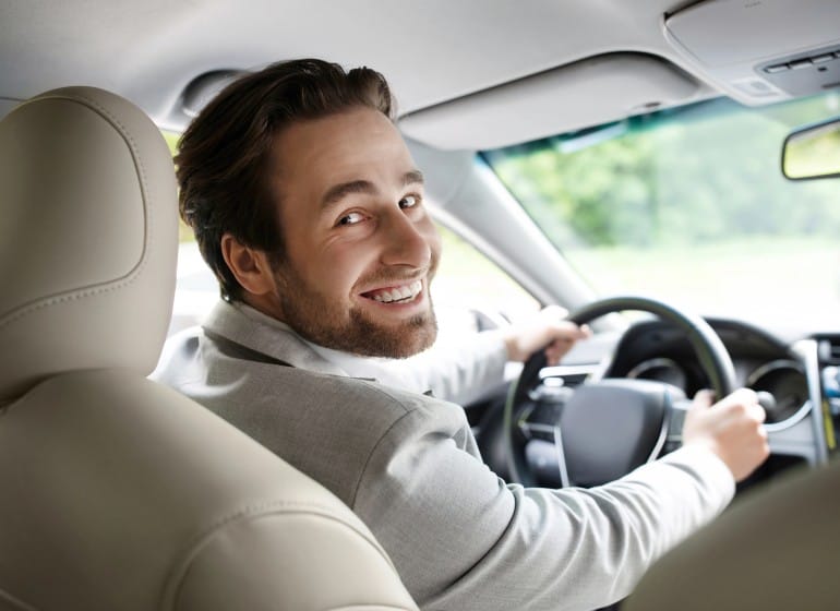 Happy guy driving a car