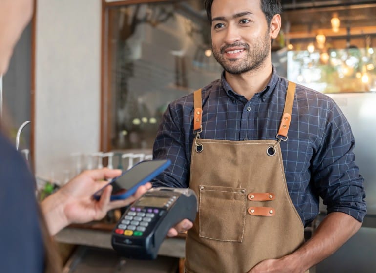 Shopkeeper taking card payment